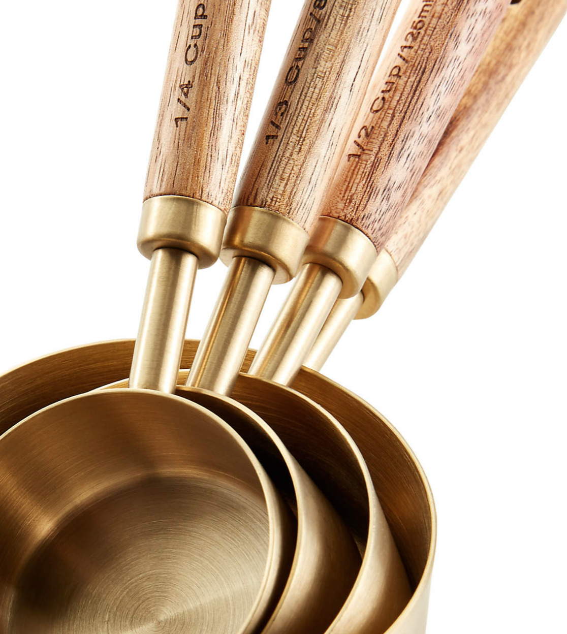 Measuring cups in gold with wooden handles