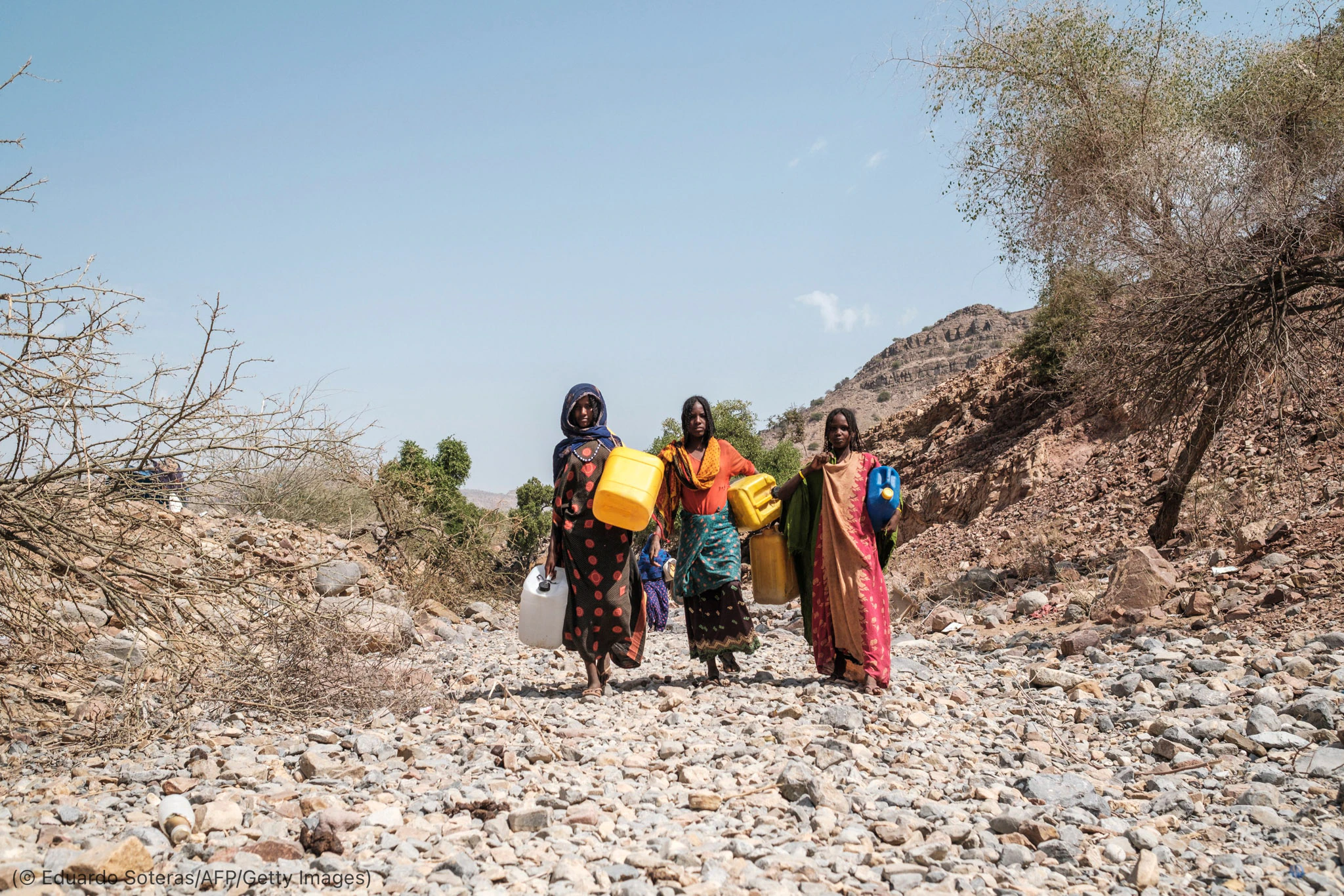 3 women carrying water containers (© Eduardo Soteras/AFP/Getty Images)