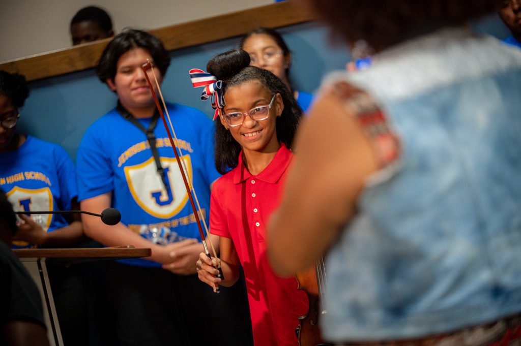 Nine-year-old violinist Laila Willis smiles as she completes her performance 